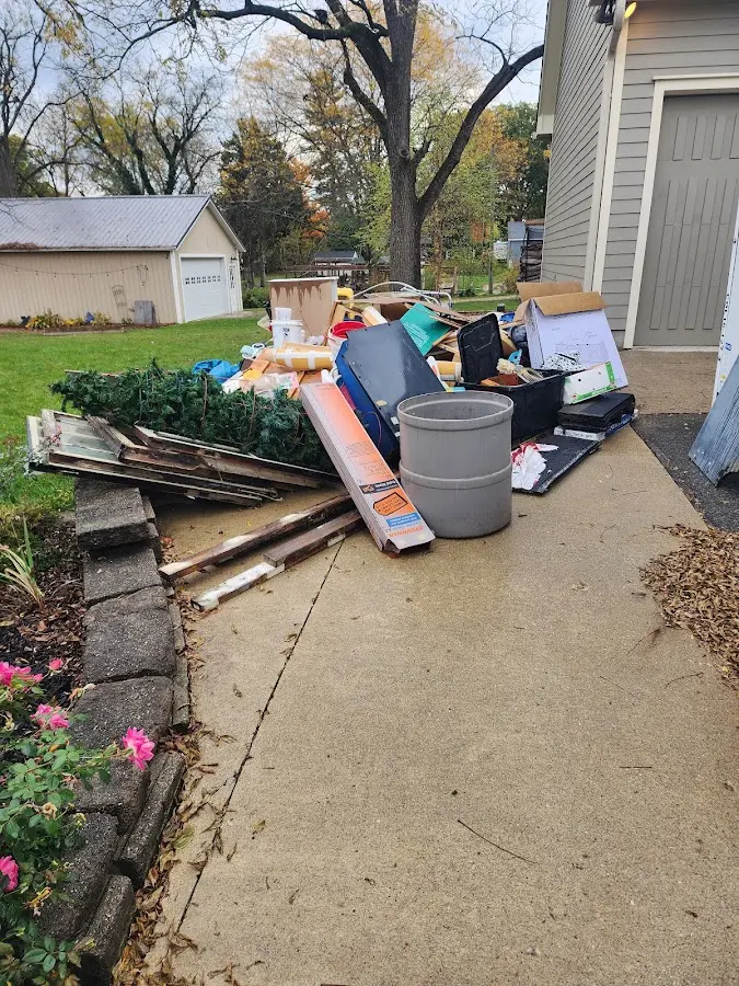 Dumpster being loaded with debris for Estate Cleanout Dumpster Rental in Lyons